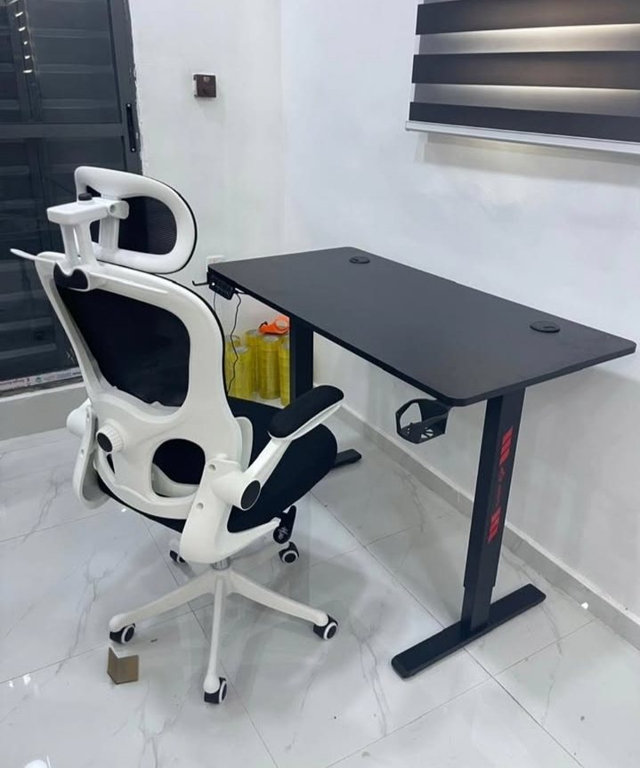 White ergonomic mesh chair at a black desk